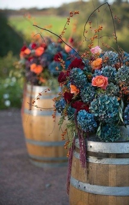 Image of flower bouquets on wine barrels in the fall
