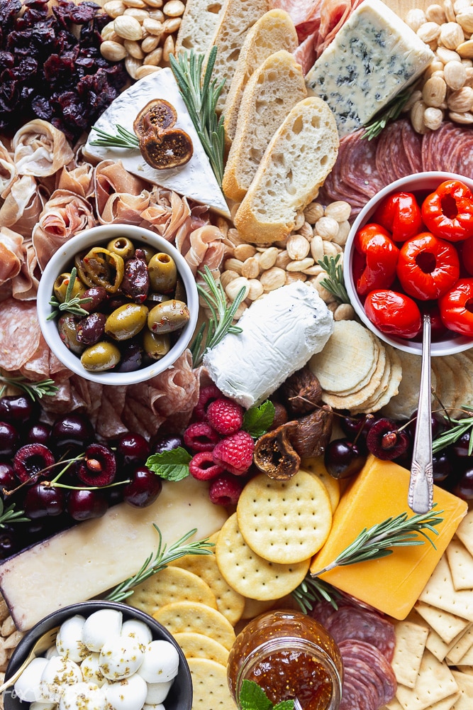 Image of a tray of charcuterie, cheese, nuts and olives