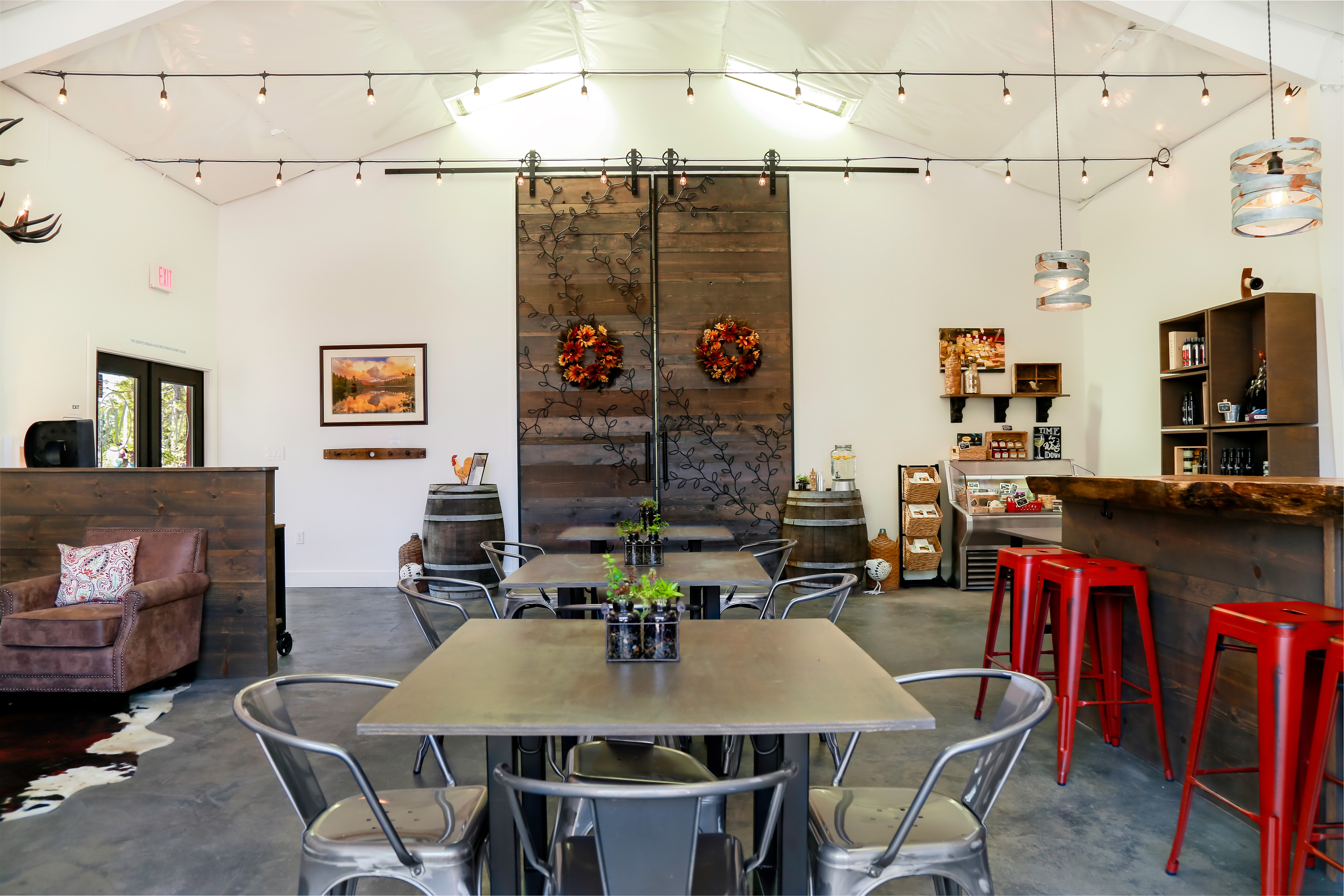 Image of large barn doors and tables and chairs for inside seated tastings